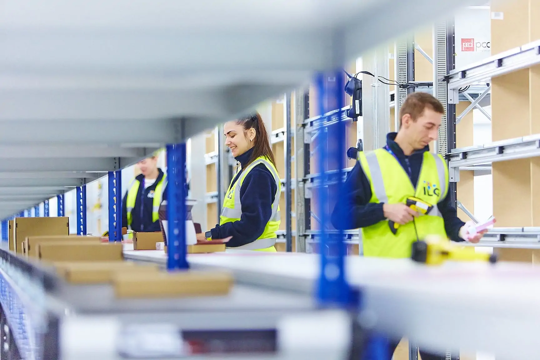 ILG staff using conveyor belt in warehouse