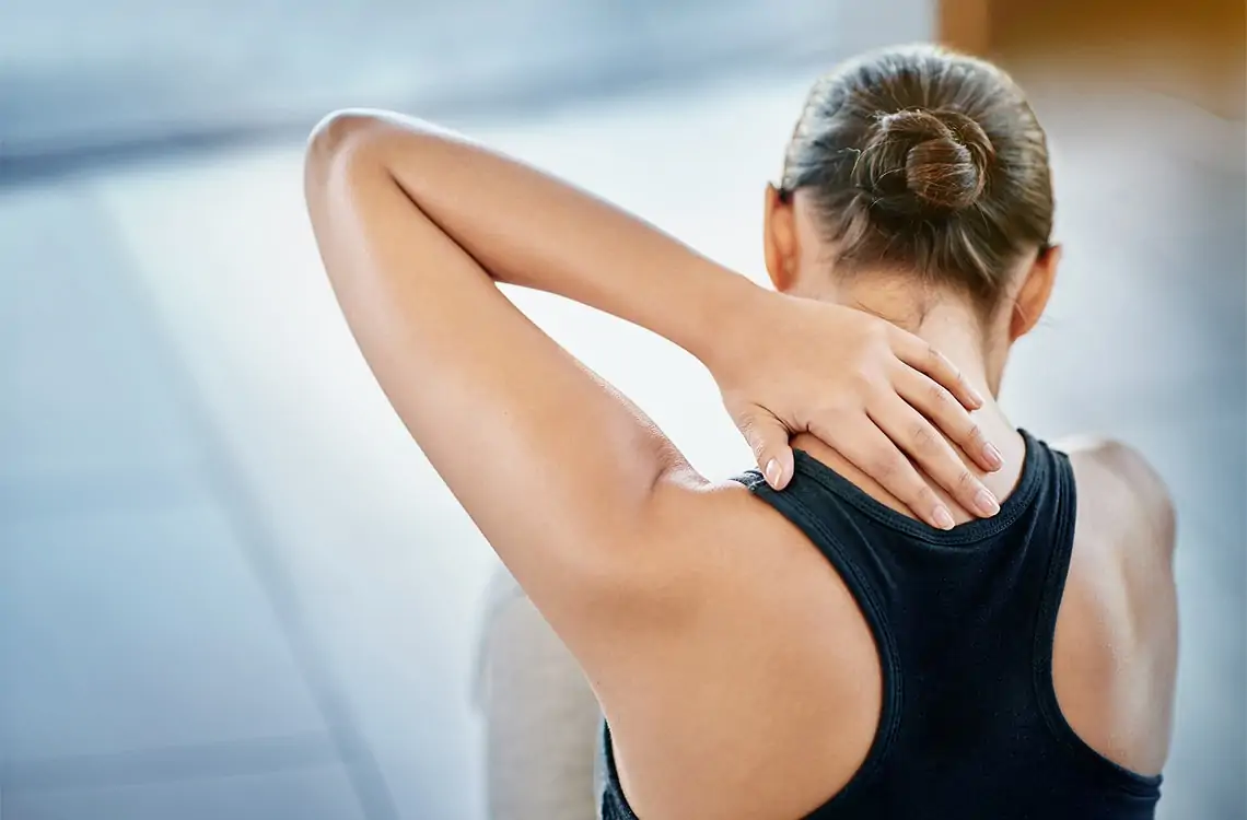 A woman stretching her neck and back