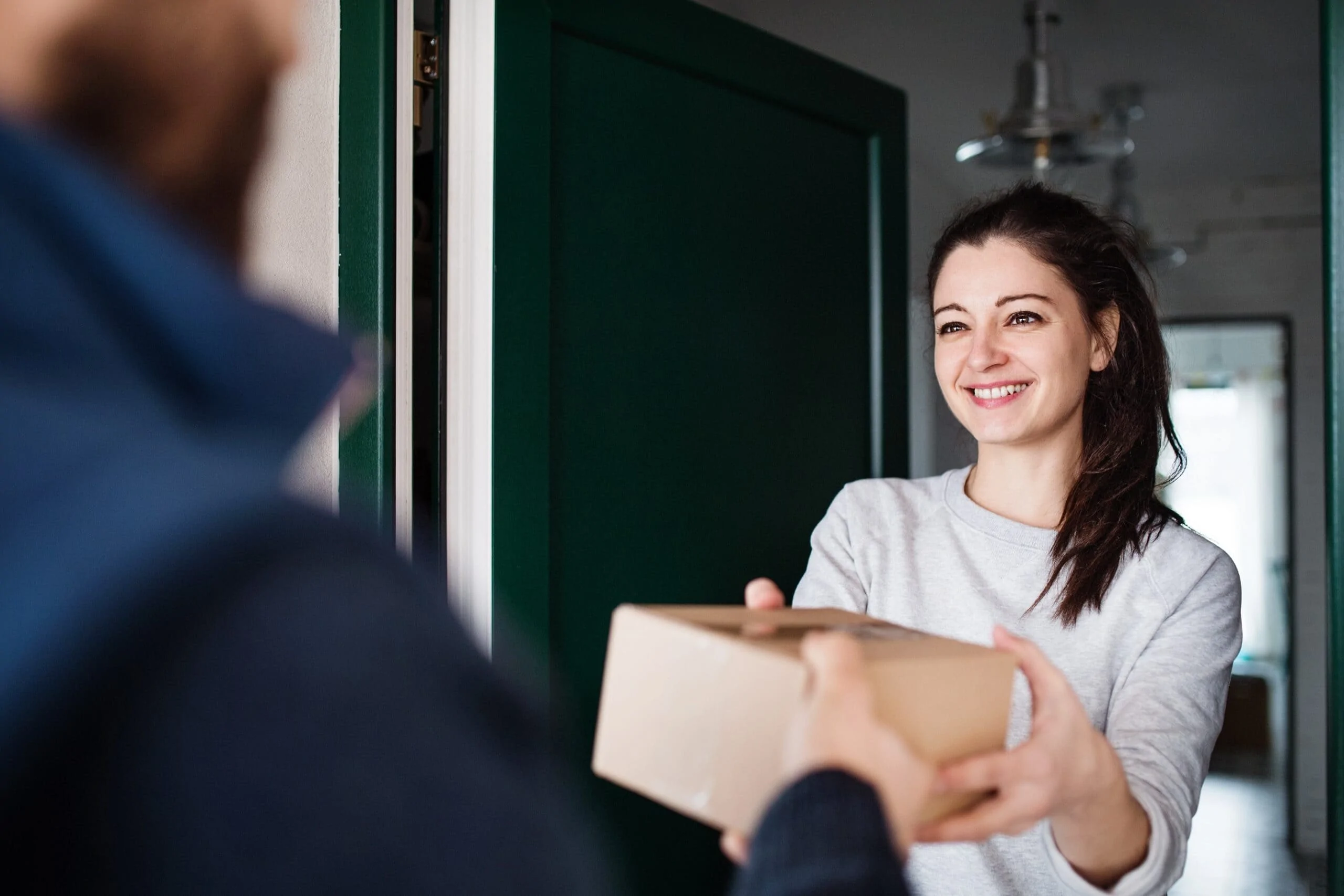Lady receiving parcel at her door