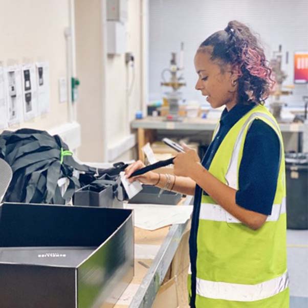 Junior ILG employee sorting packaging tags