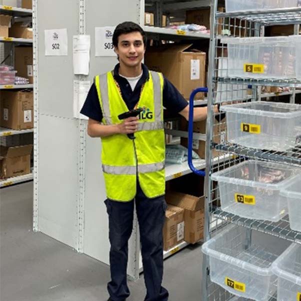 Junior ILG employee scanning items in warehouse