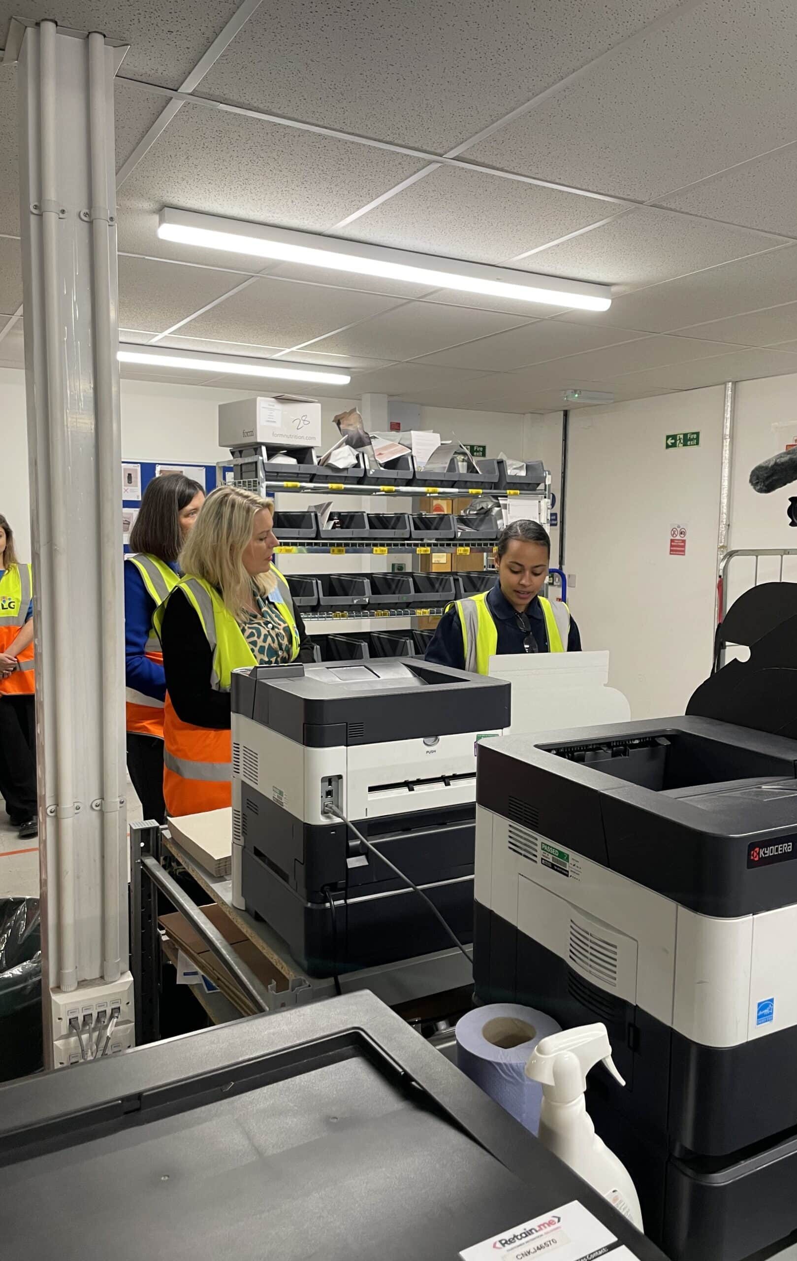 Junior ILG employees showing guest around warehouse