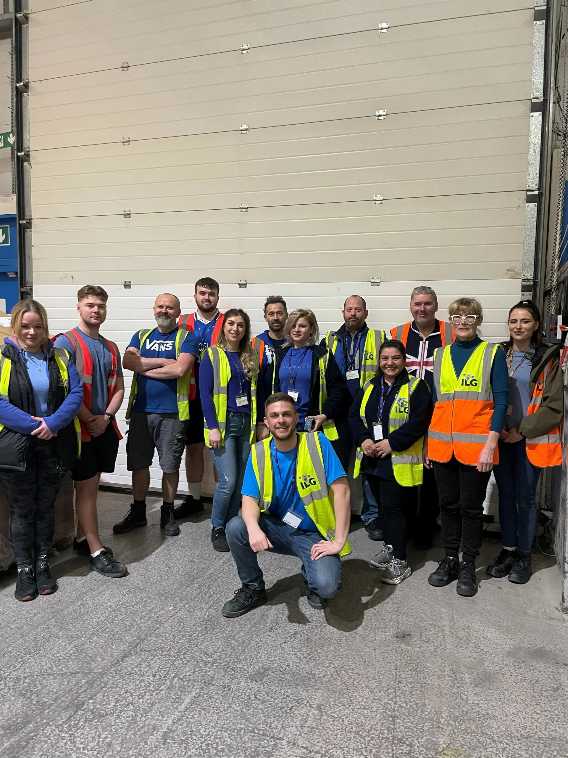 Group of ILG employees standing outside of a warehouse door