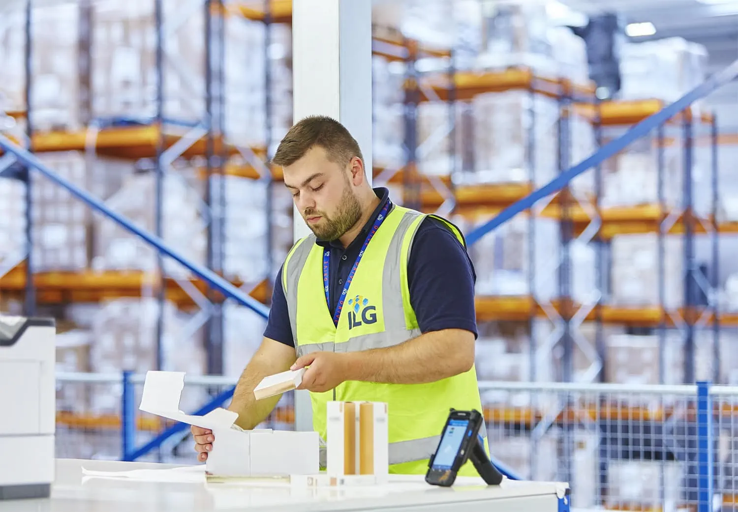 Man packing boxes in ILG hi viz