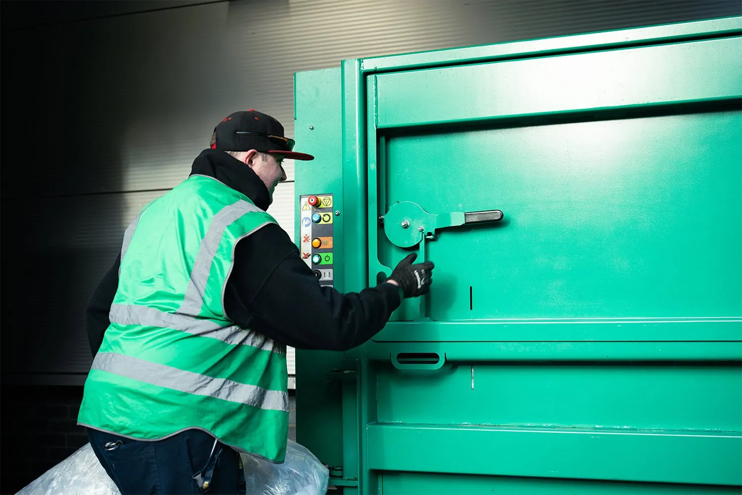 Man using plastic baler ILG