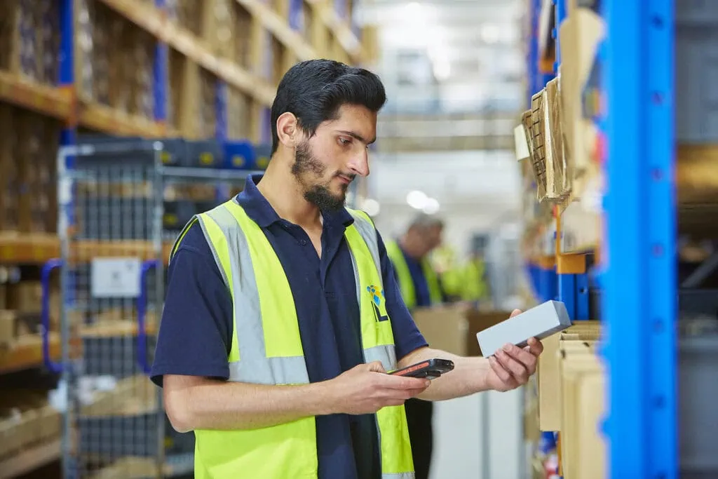Man scanning box in warehouse