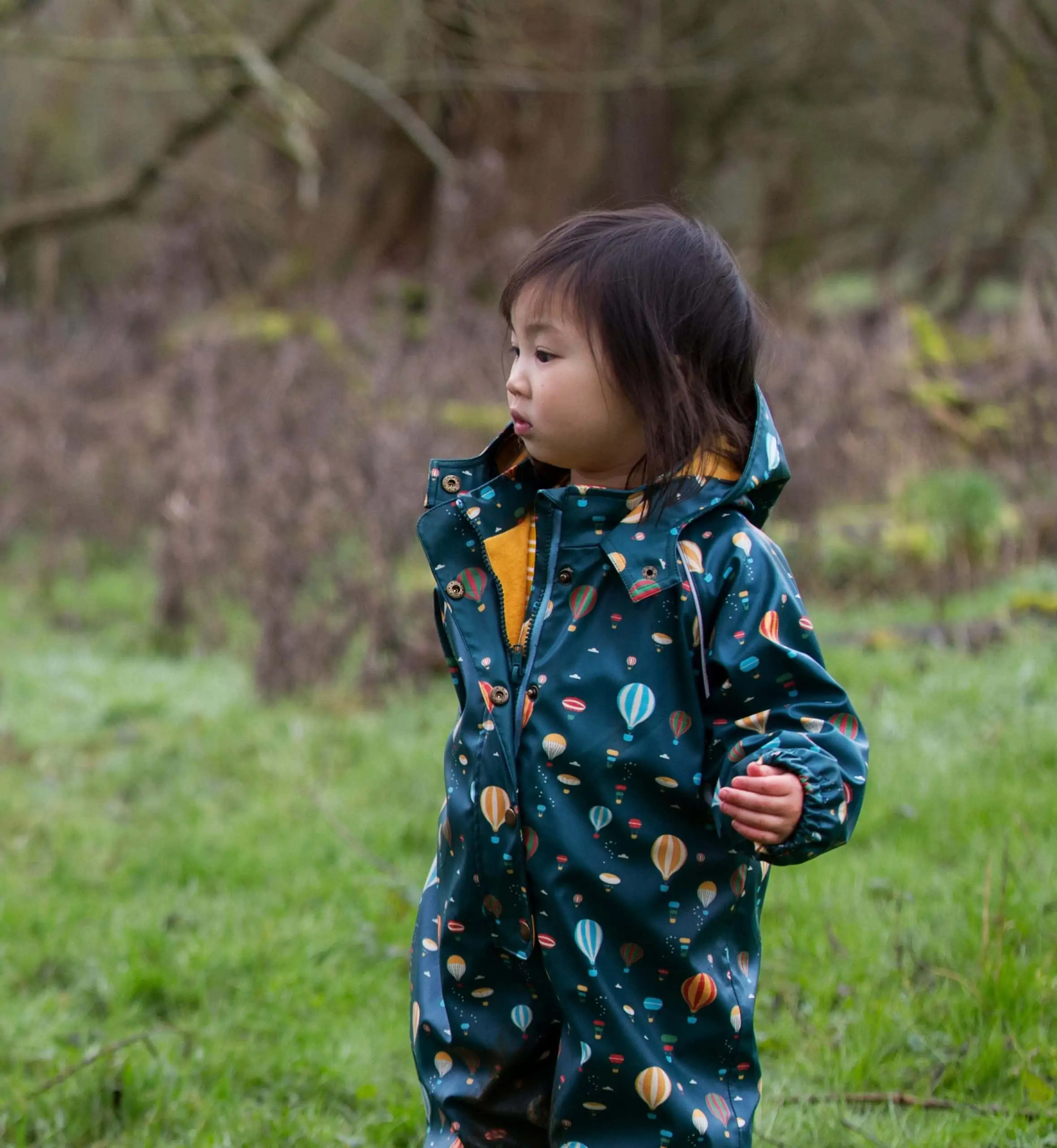 Child modelling Little Green Radicals clothes in a field