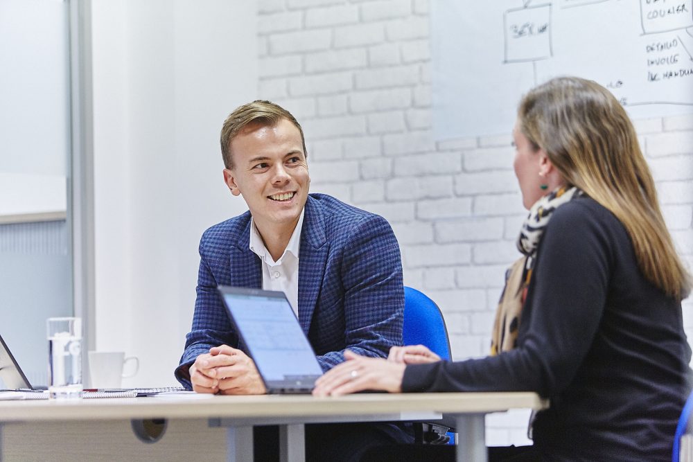 man and woman having a meeting in an office