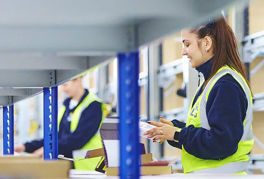 ILG employee packing an order in the warehouse