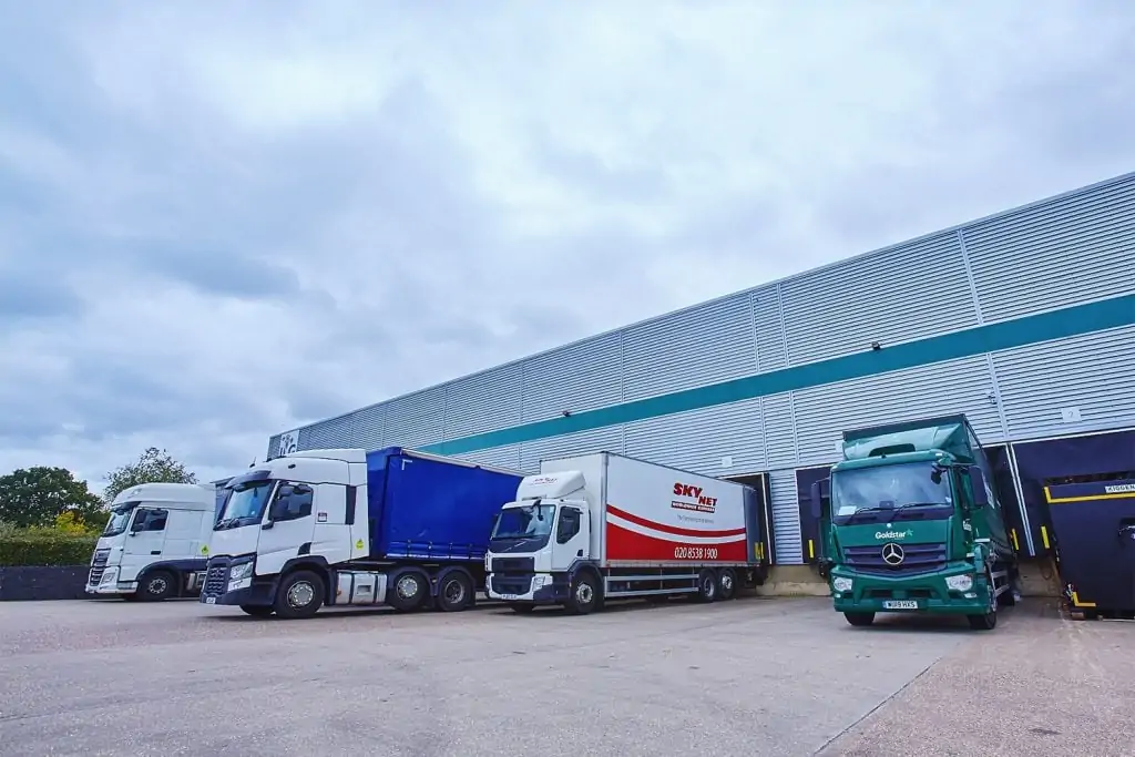 multiple lorries lined up at loading docks of an ILG warehouse