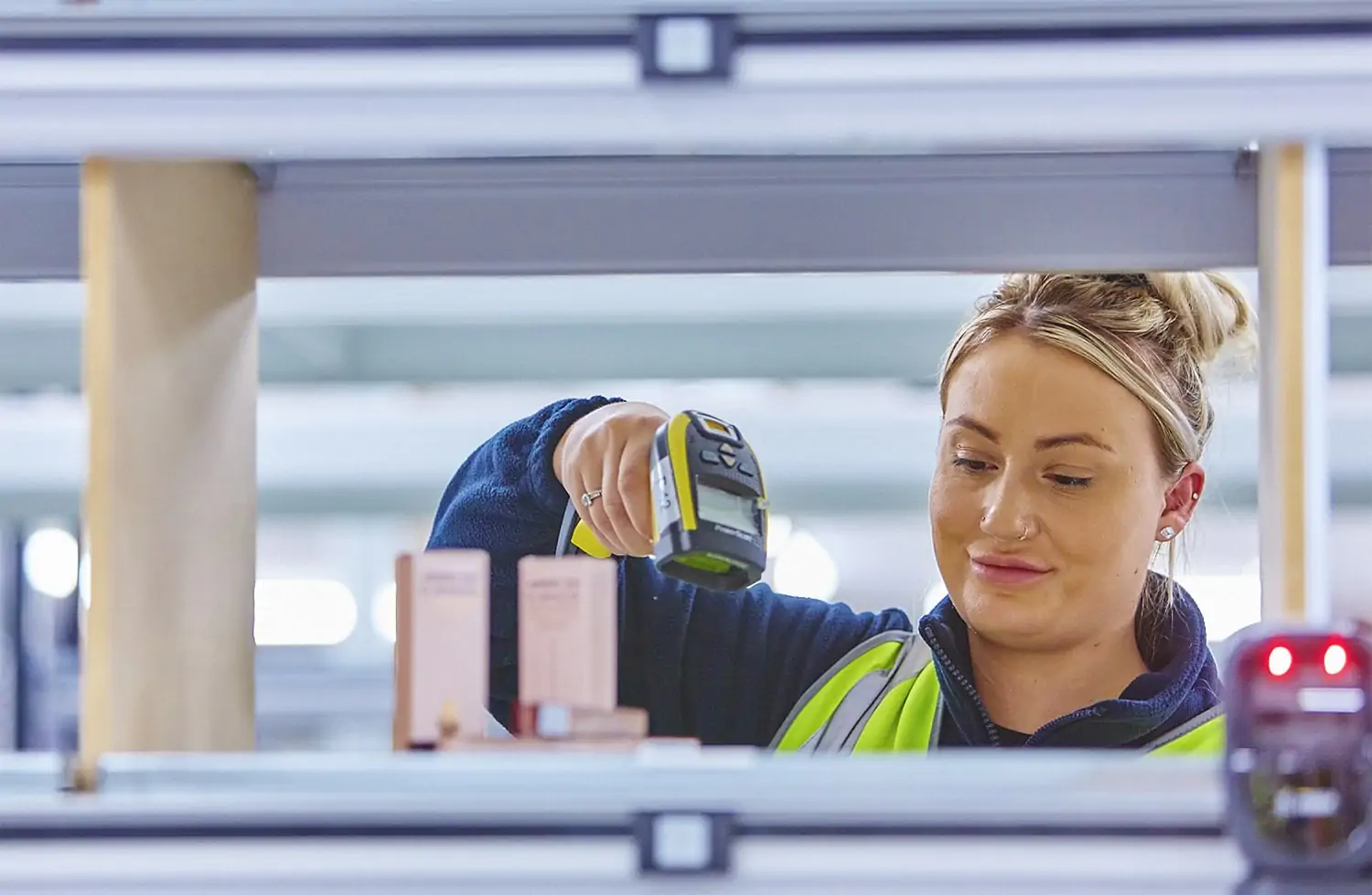 ILG employee scanning a shelf and smiling