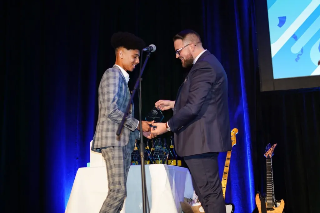 Team member accepting an award on stage
