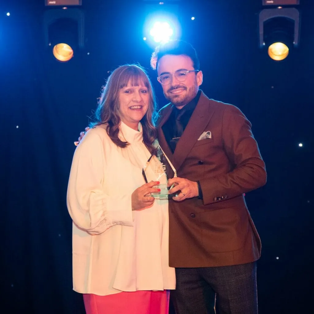 Amanda Chalkley collecting award on stage