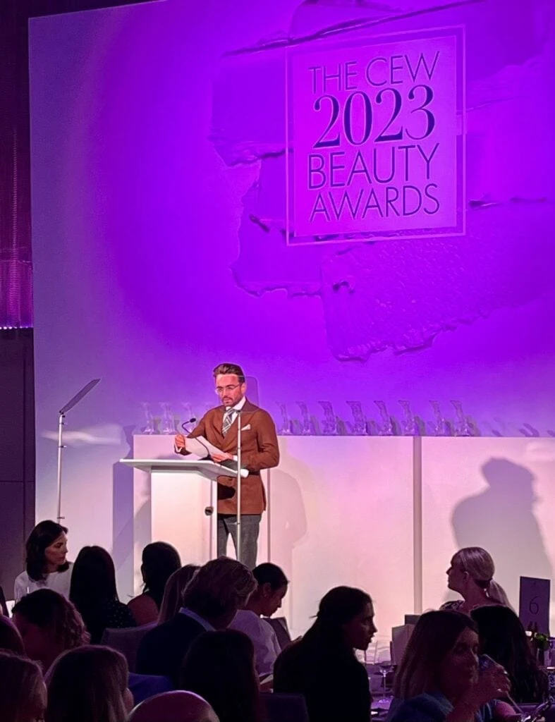 Talking at podium at CEW Beauty Awards