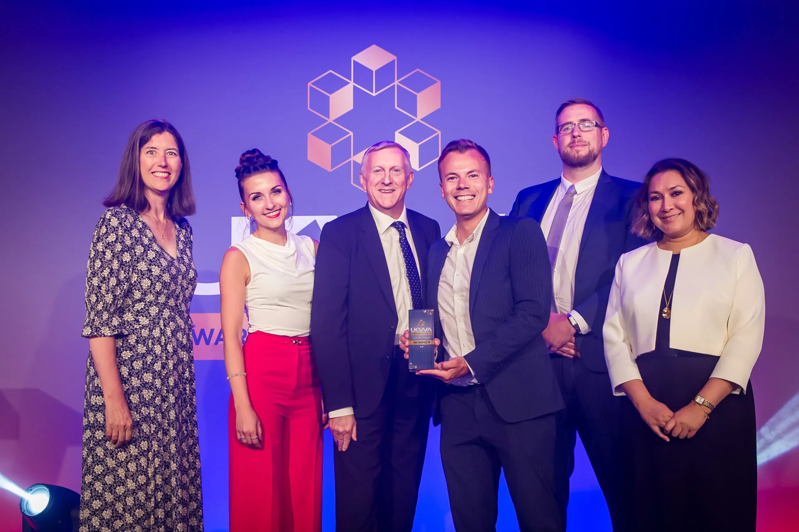 Group accepting UKWA award on stage