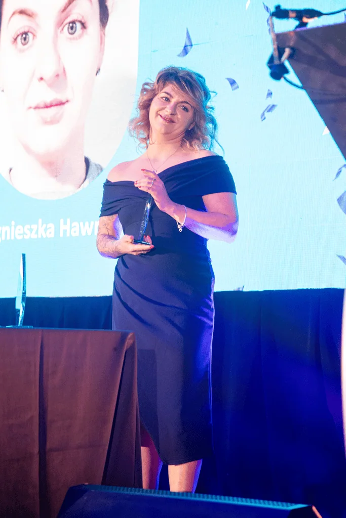 Agneskia accepting award on stage