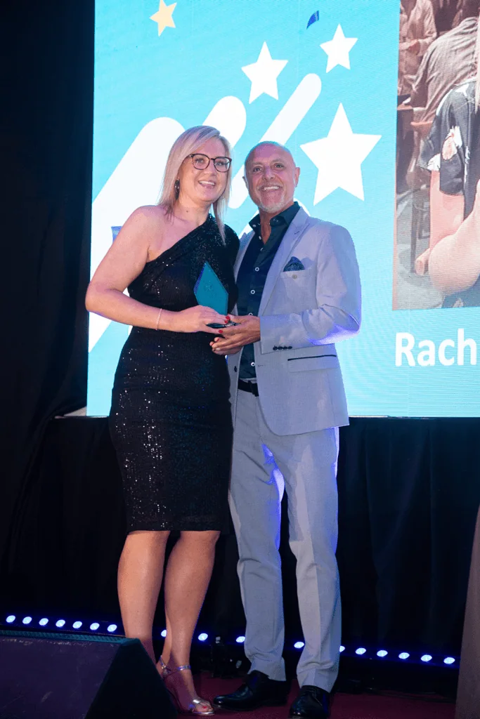Rachel accepting award on stage from Mike Stephenson