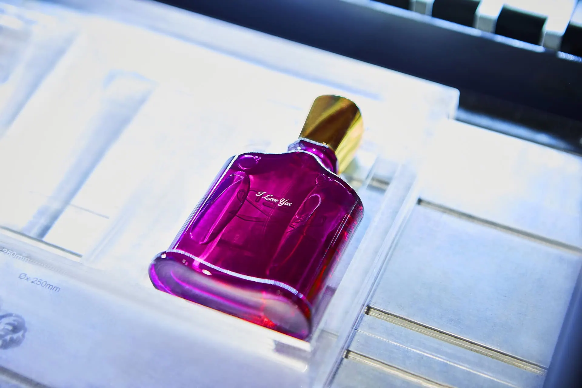 Creed perfume bottle in an engraving machine personalized with 'I love you'