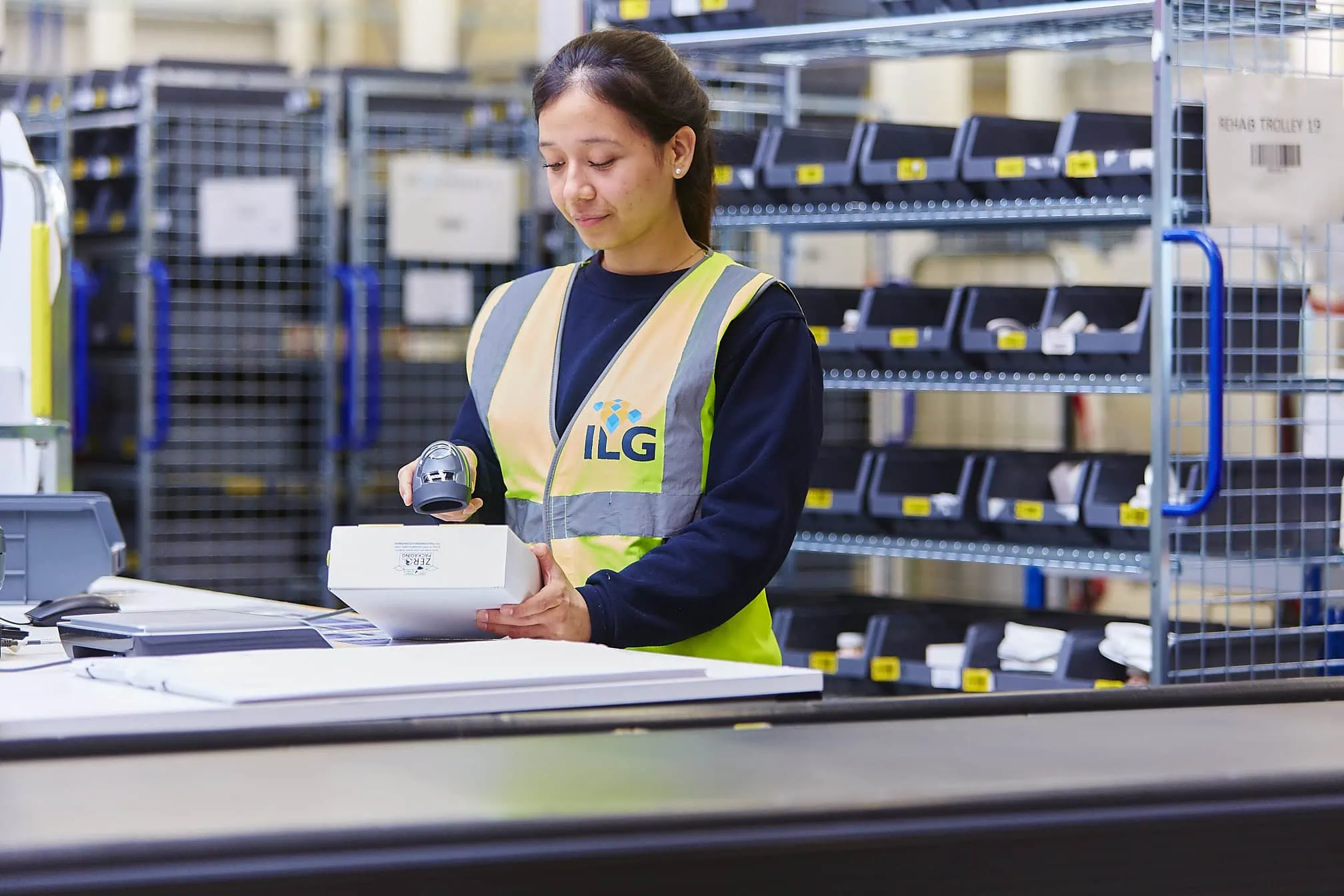 lady scanning box at shipping desk