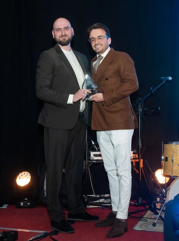 Andy Parsons accepting award on stage