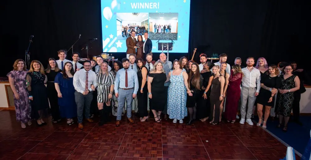 Customer Service team accepting award on stage