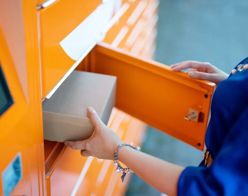 person taking package out of parcel locker