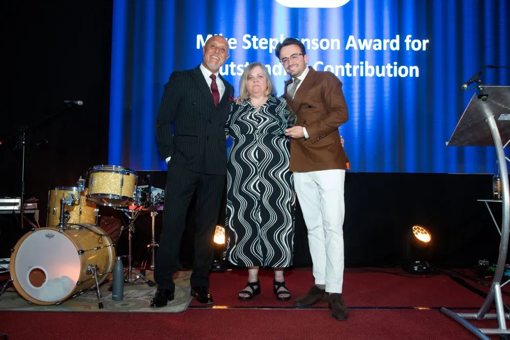 Helen Nichols accepting award on stage